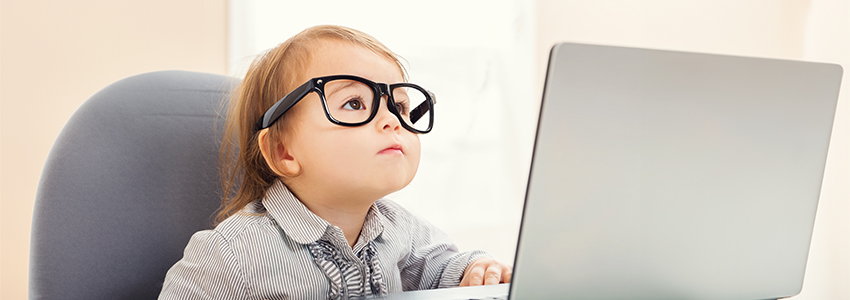 little girl sitting a computer