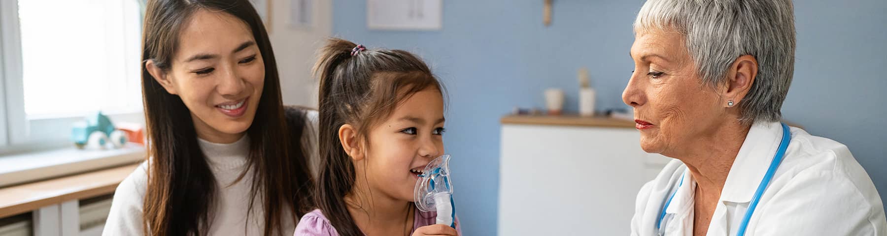 A young girl with her mother and doctor testing for allergies.