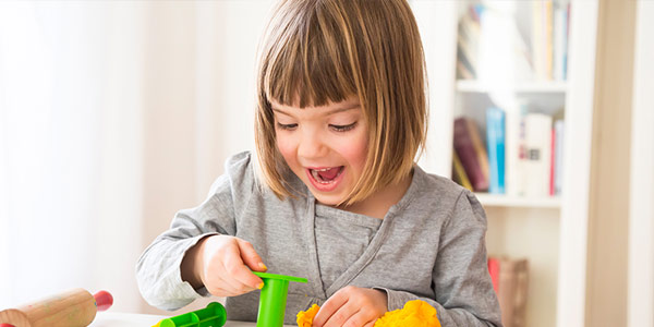 Young girl playing with therapeutic toys.